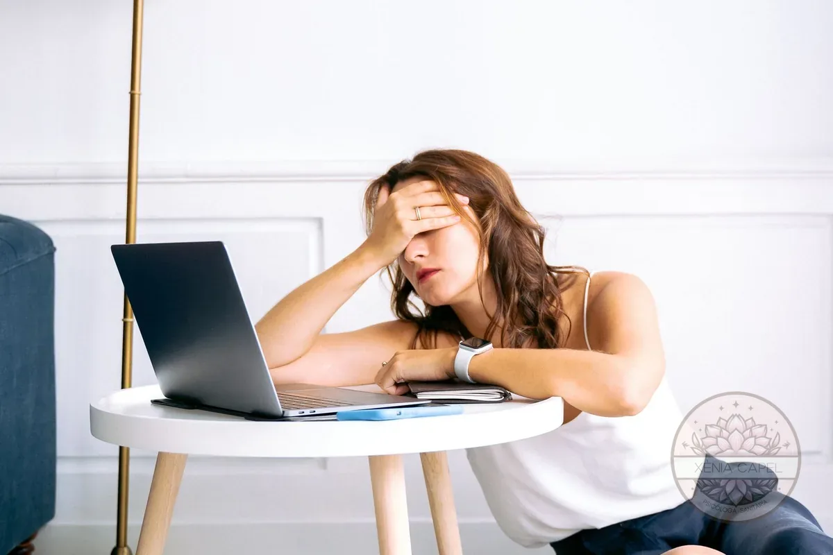 Apathy and lack of motivation: woman with low energy and a drained expression, not up to anything in front of her laptop