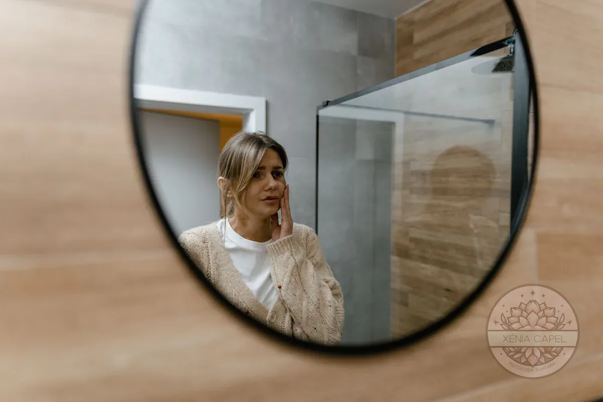 Body dysmorphia: a woman examines her face in the mirror with concern, a typical behaviour of body dysmorphic disorder