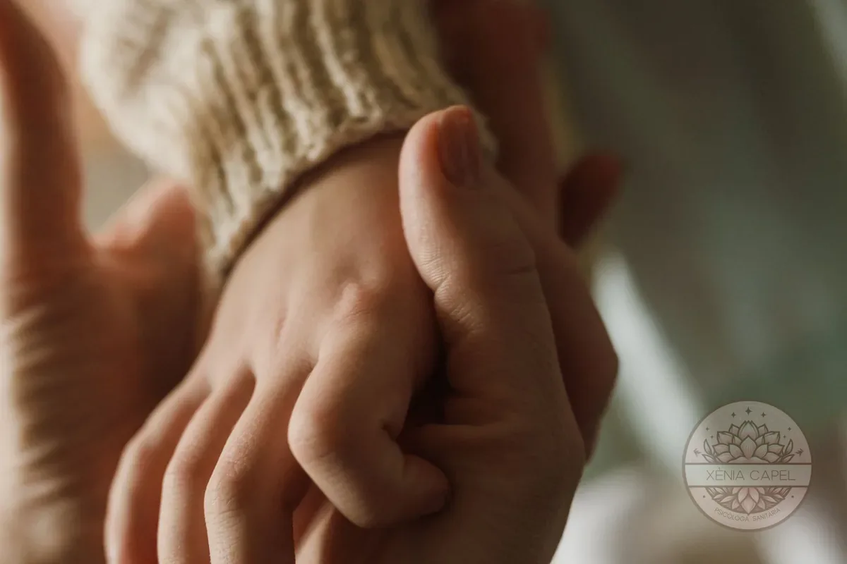 Childhood wounds: an adult hand gently holding a child's hand, a symbol of healing the inner child