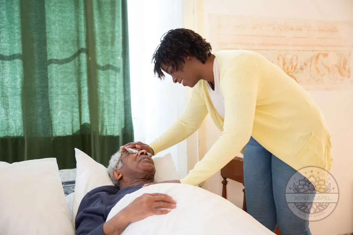 Caregiver burnout: a caregiver tenderly tending to an elderly man in bed at home